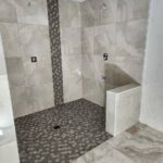 Shower renovation completed – sleek design with modern fixtures and finishes.