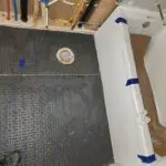 The remodeling process: installing underfloor heating in the bathroom for a seamless and comfortable upgrade.