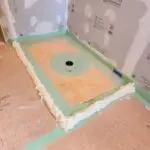 Using mounting foam for precise and secure bathroom remodel installations.